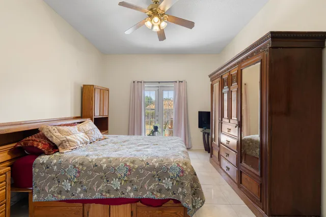 a bedroom with a large bed and a chandelier