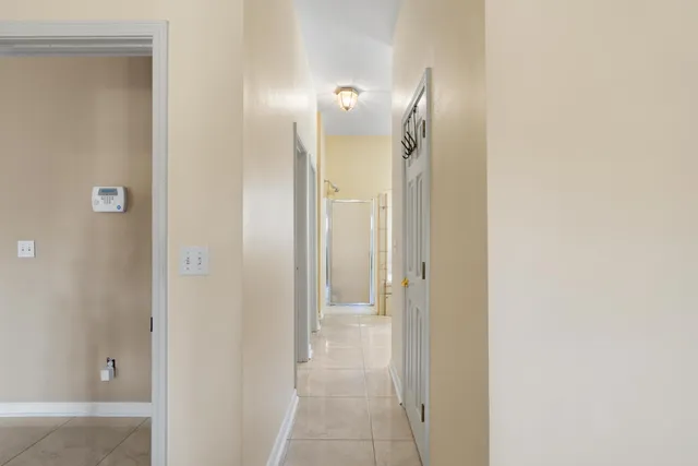 a view of a bathroom from the hallway with toilet
