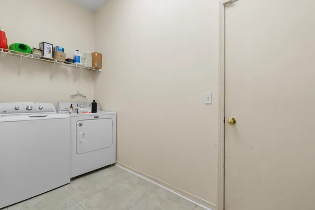 a view of storage and utility room with washer and dryer