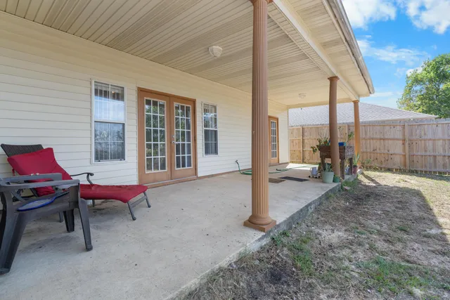 a backyard of a house with outdoor seating