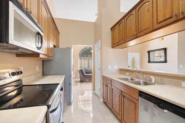 a kitchen with stainless steel appliances granite countertop a sink stove and refrigerator