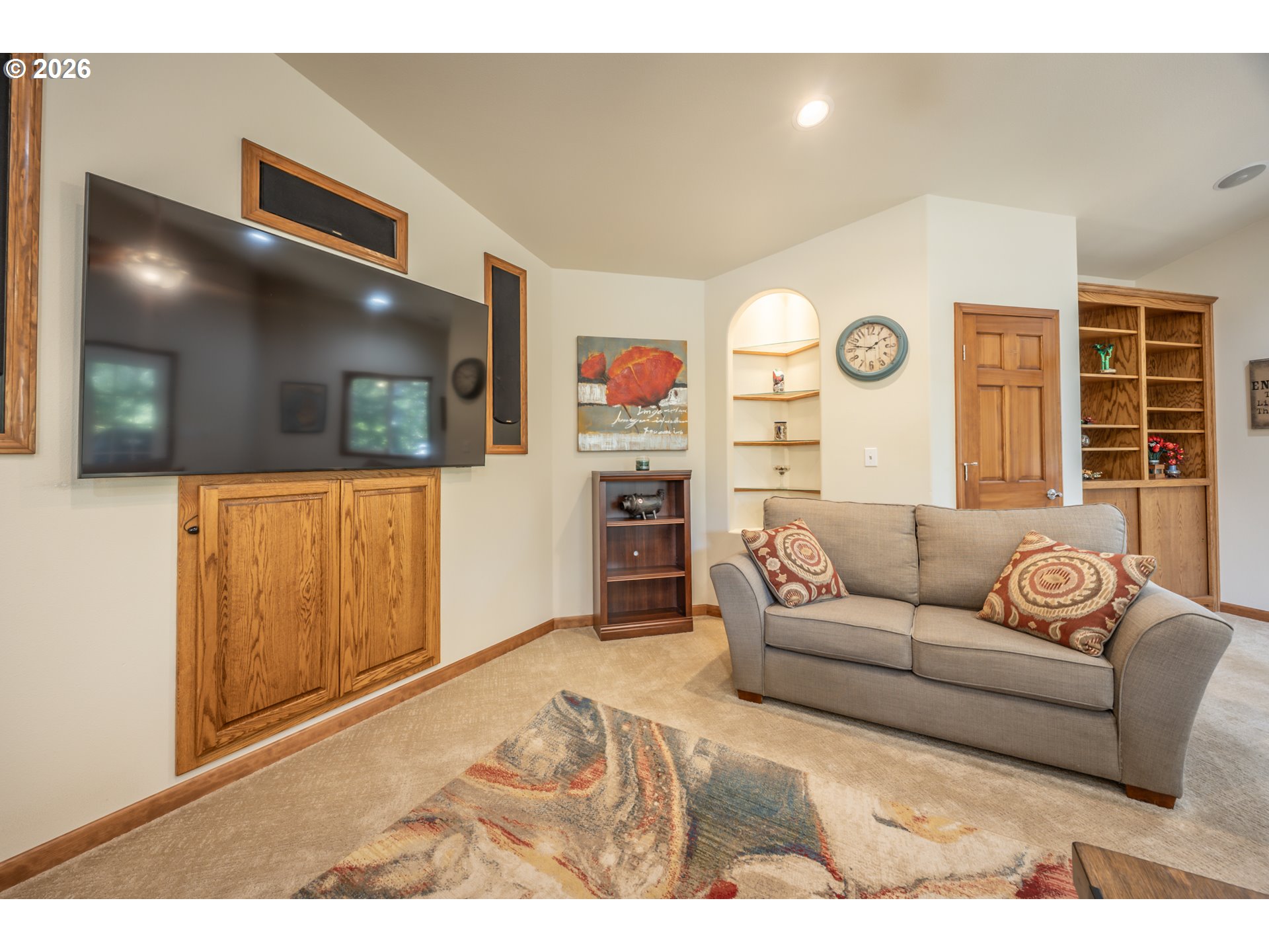 2193 13th Street Florence, OR 97439 - Photo 24 of 48 a living room with furniture and a flat screen tv