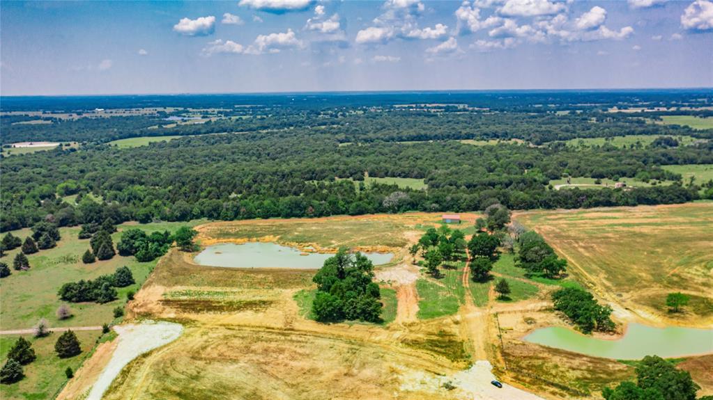 1789 Brumelow Road Whitesboro, TX 76273 - Photo 11 of 30 Expansive rural landscape featuring multiple ponds, scattered mature trees, and varying terrain