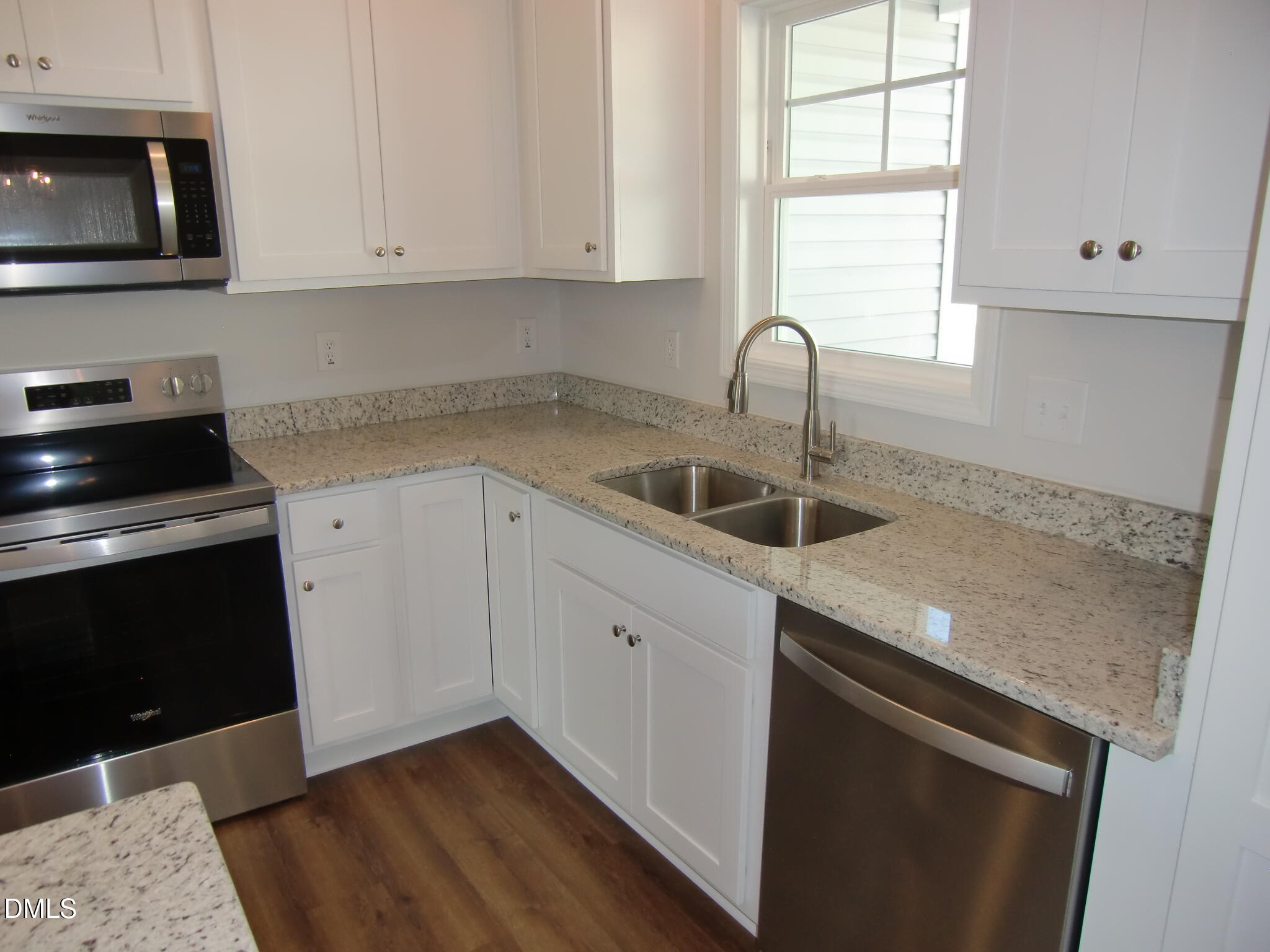 100 Covington Lane Dunn, NC 28334 - Photo 30 of 61 a kitchen with granite countertop white cabinets and a sink
