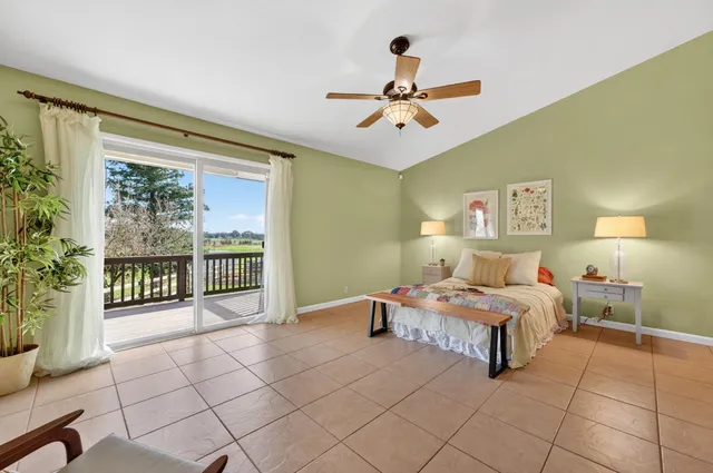 a bedroom with a bed and ceiling fan