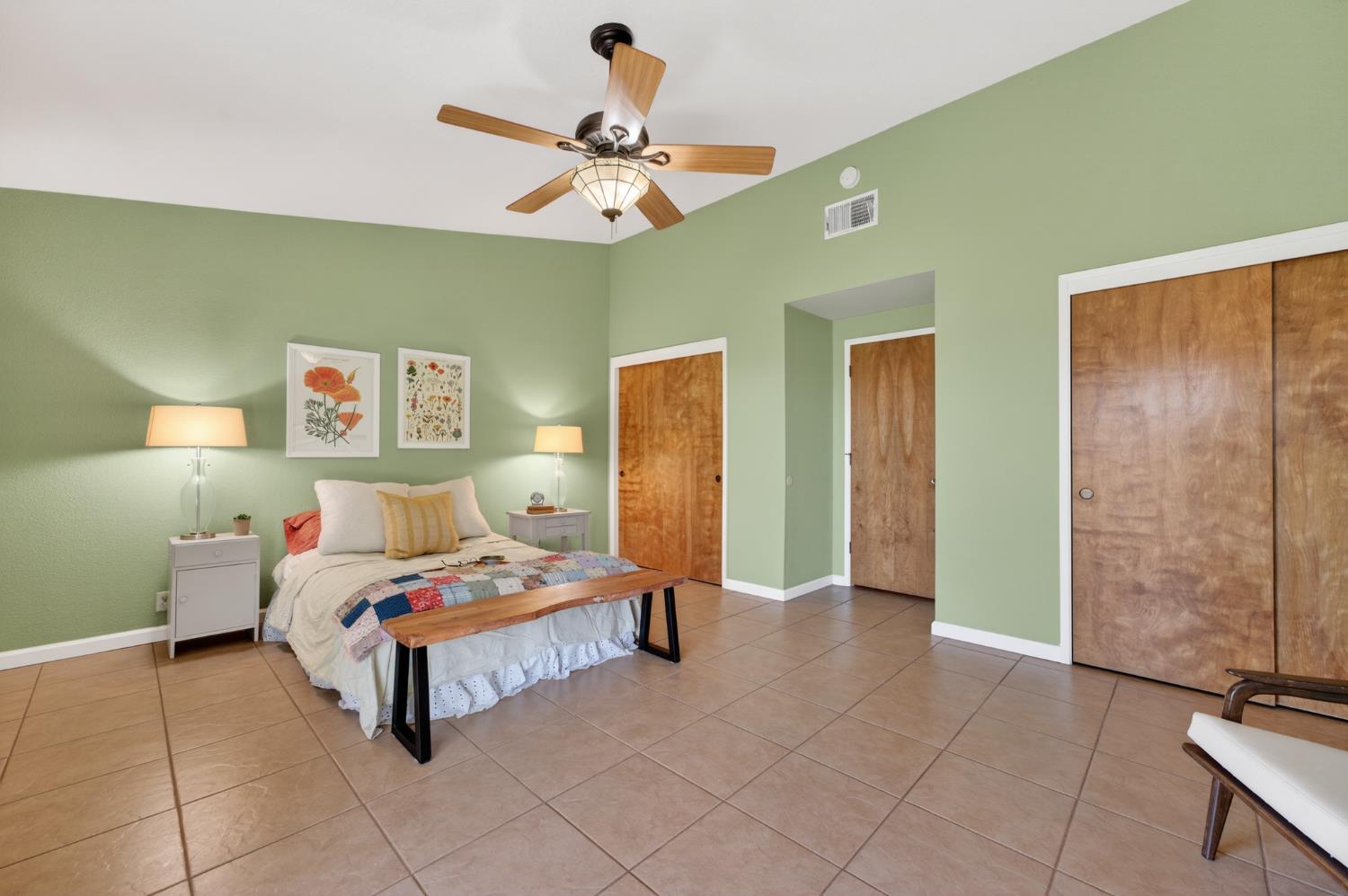 10919 Alta Mesa Road Wilton, CA 95693 - Photo 19 of 66 a bedroom with a bed and a chandelier