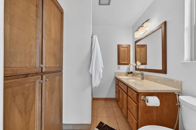 a bathroom with a sink a toilet and mirror