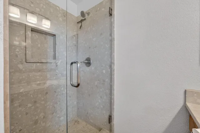 a bedroom with two beds and a window