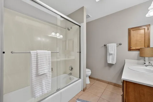 a bathroom with a sink a light fixture and a mirror