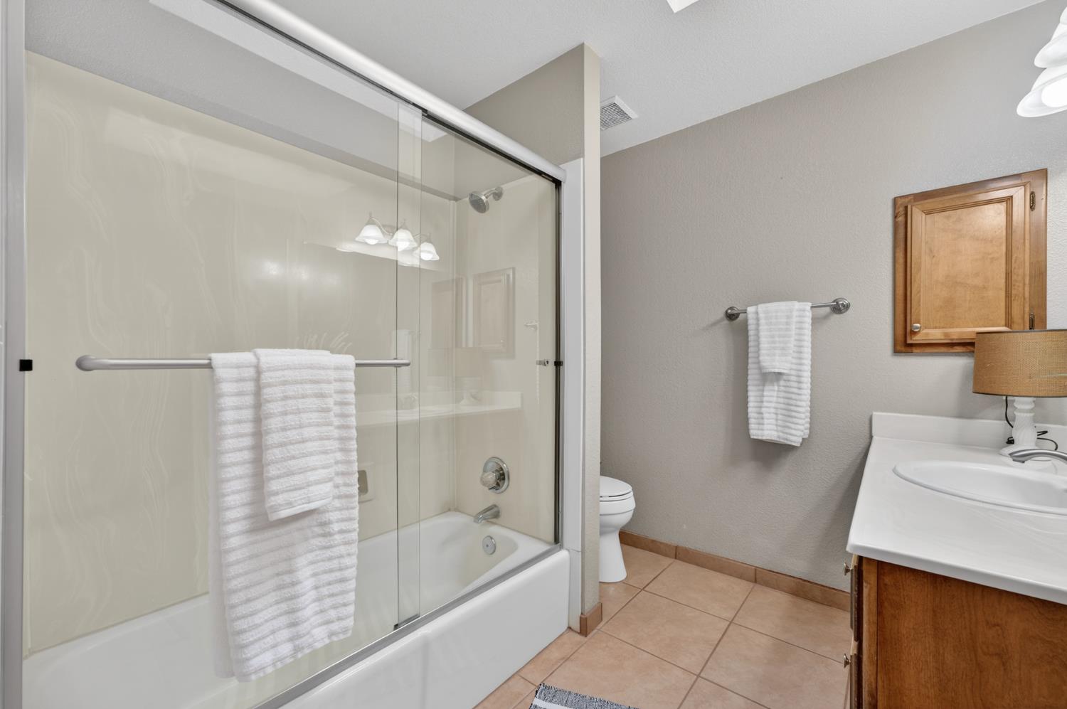 10919 Alta Mesa Road Wilton, CA 95693 - Photo 27 of 66 a bathroom with a bathtub a shower a sink and a mirror