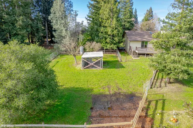 a view of a swimming pool with a yard