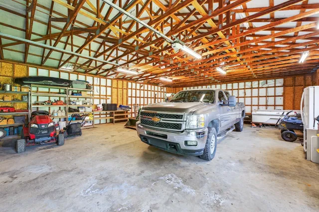 an aerial view of a house with a yard basket ball court and outdoor seating