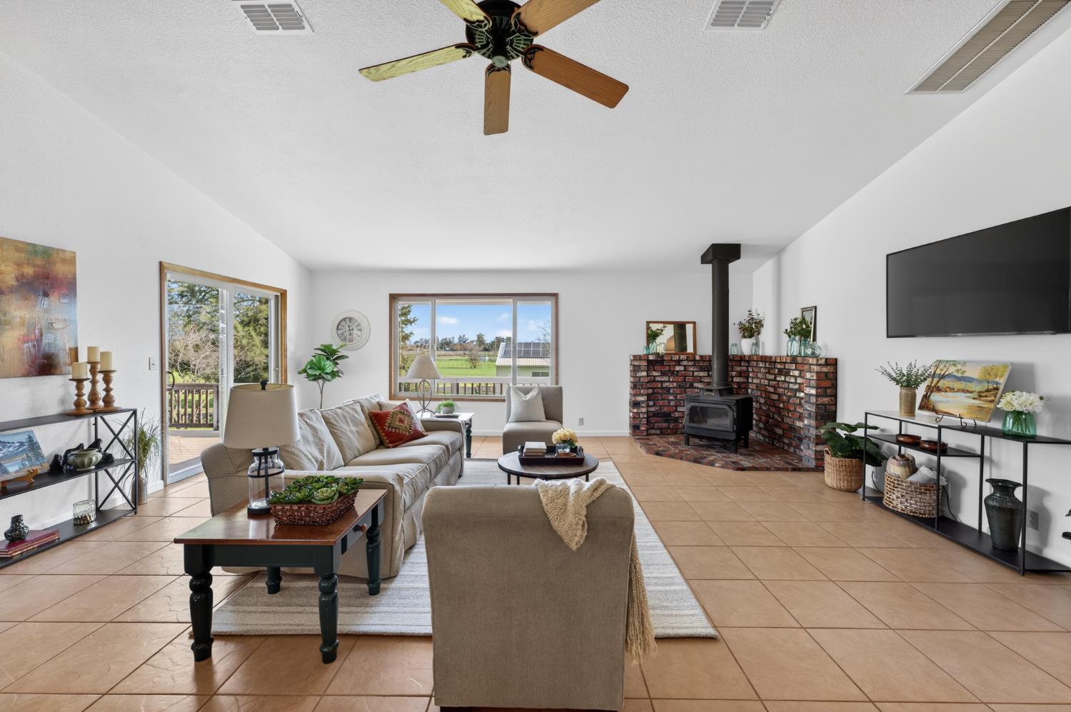 10919 Alta Mesa Road Wilton, CA 95693 - Photo 5 of 66 a living room with furniture and a flat screen tv