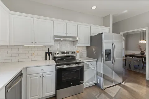 a kitchen with cabinets appliances and a sink