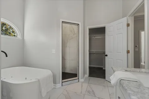 a bathroom with a bathtub and a shower