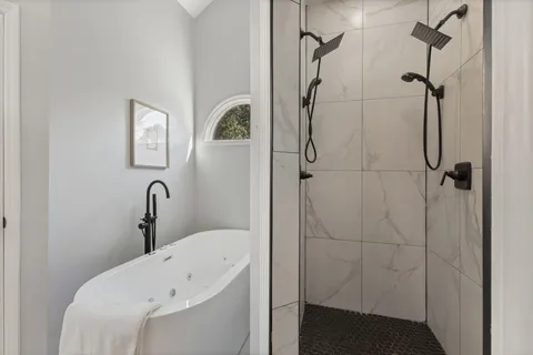 a bathroom with a bathtub and shower