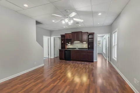 a kitchen with stainless steel appliances a refrigerator and a wooden floor