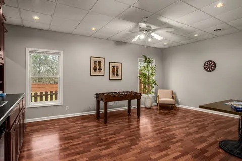 a living room with furniture and a wooden floor