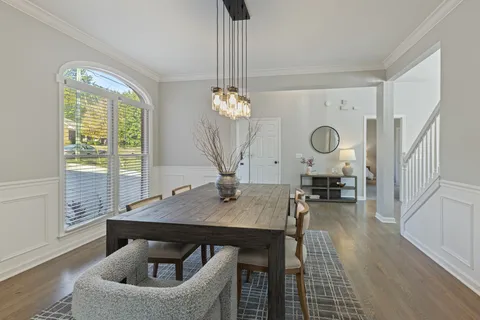 a view of a dining room with furniture window and wooden floor