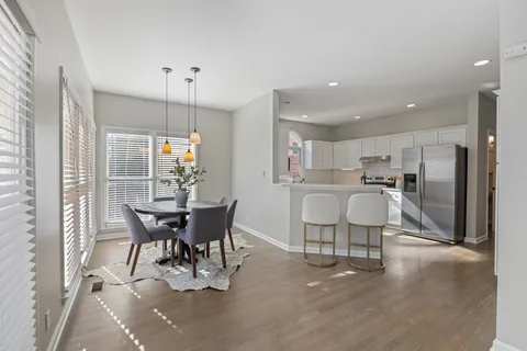 a view of a dining room with furniture and wooden floor