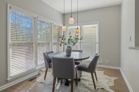 a view of a dining room with furniture and windows