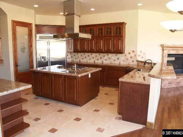12815 Silver Wolf Road Reno, NV 89511 - Photo 6 of 9 a kitchen with a sink refrigerator and cabinets