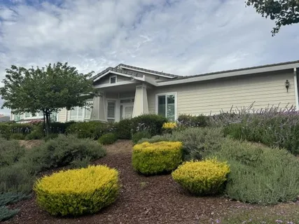 a view of a house with a sink and a yard