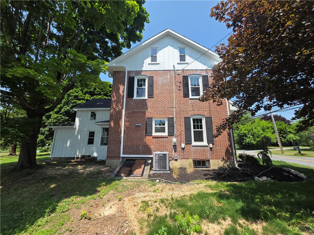 Discover a traditional brick residence, nestled amidst mature trees, offering timeless appeal.