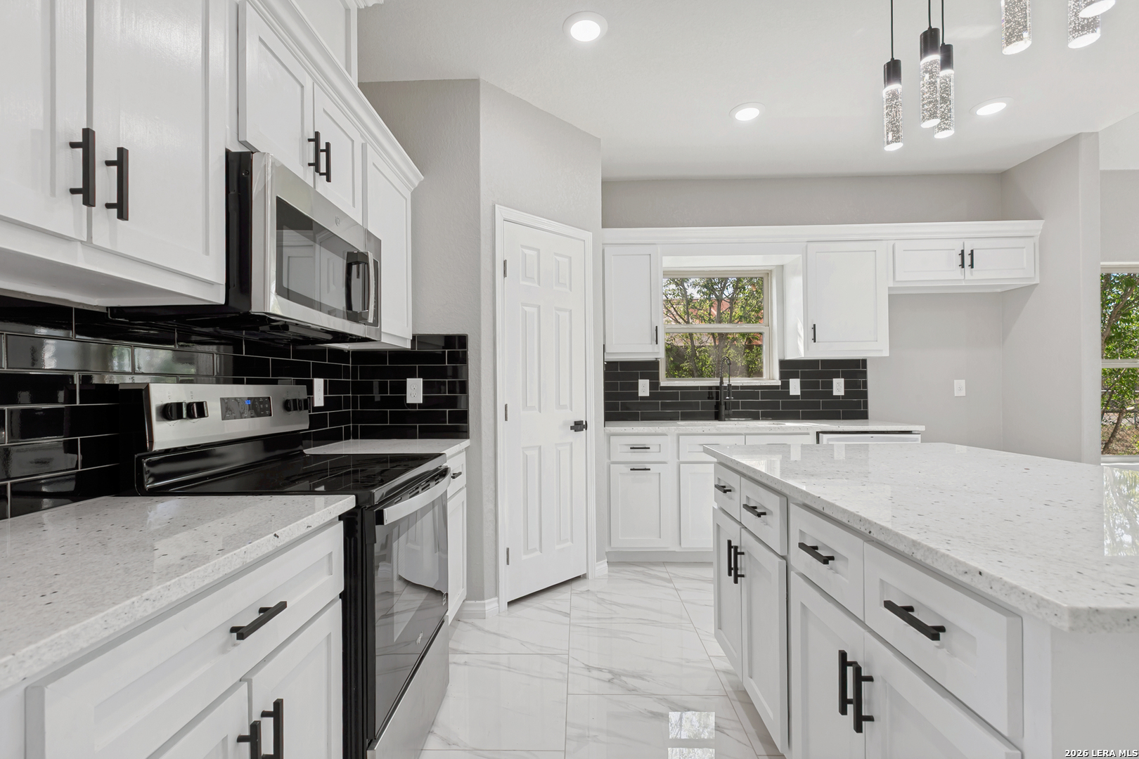 237 Avenue D Poteet, TX 78065 - Photo 12 of 27 a kitchen with stainless steel appliances granite countertop a stove and a sink