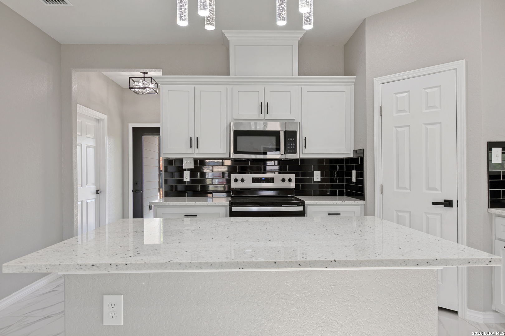237 Avenue D Poteet, TX 78065 - Photo 15 of 27 a kitchen with stainless steel appliances a stove a microwave and a refrigerator