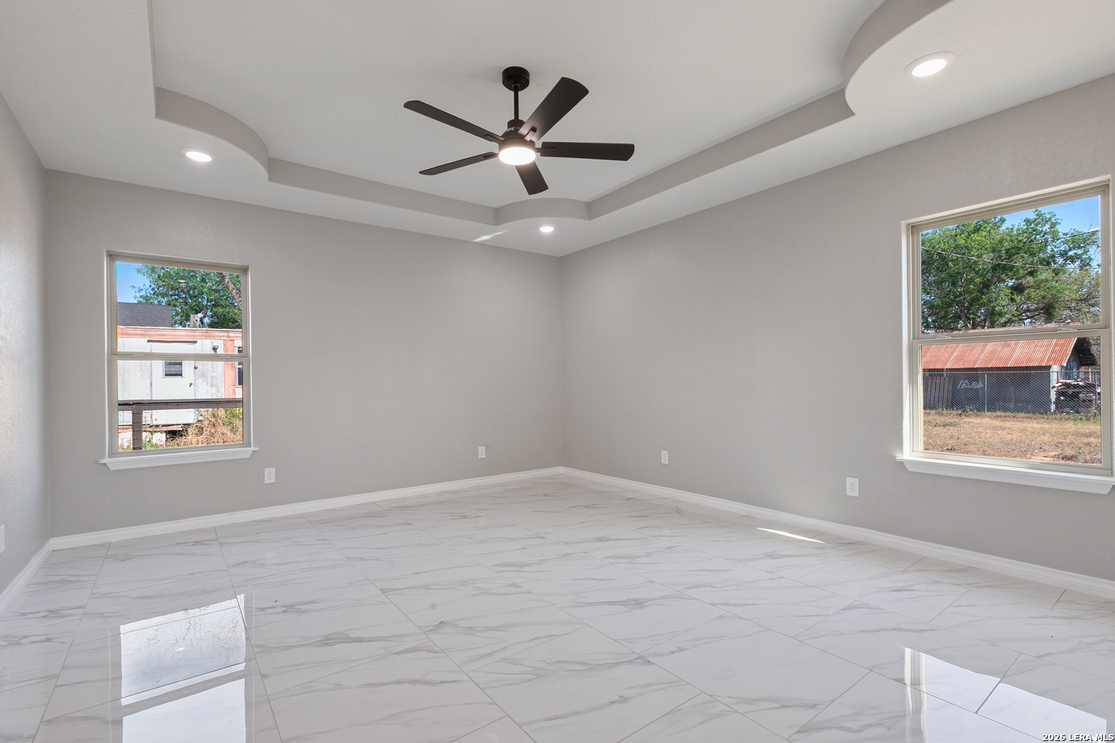 237 Avenue D Poteet, TX 78065 - Photo 18 of 27 an empty room with windows and ceiling fan