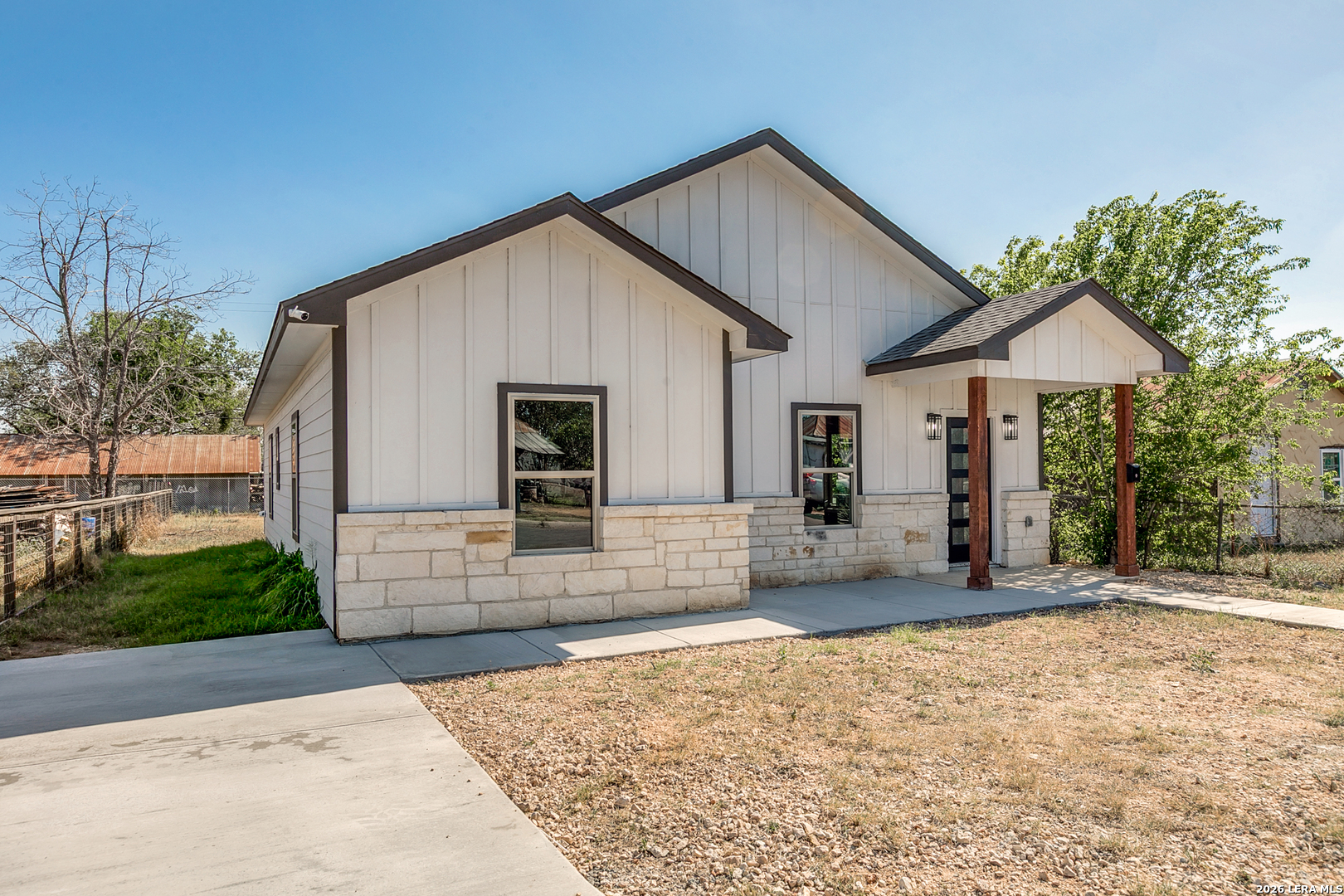 237 Avenue D Poteet, TX 78065 - Photo 3 of 27 a front view of a house with garden