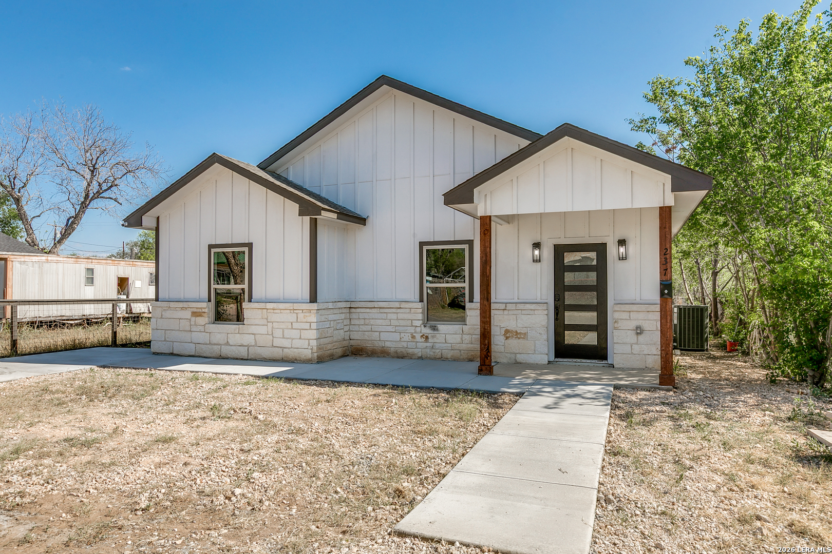 237 Avenue D Poteet, TX 78065 - Photo 4 of 27 a view of a house with a yard