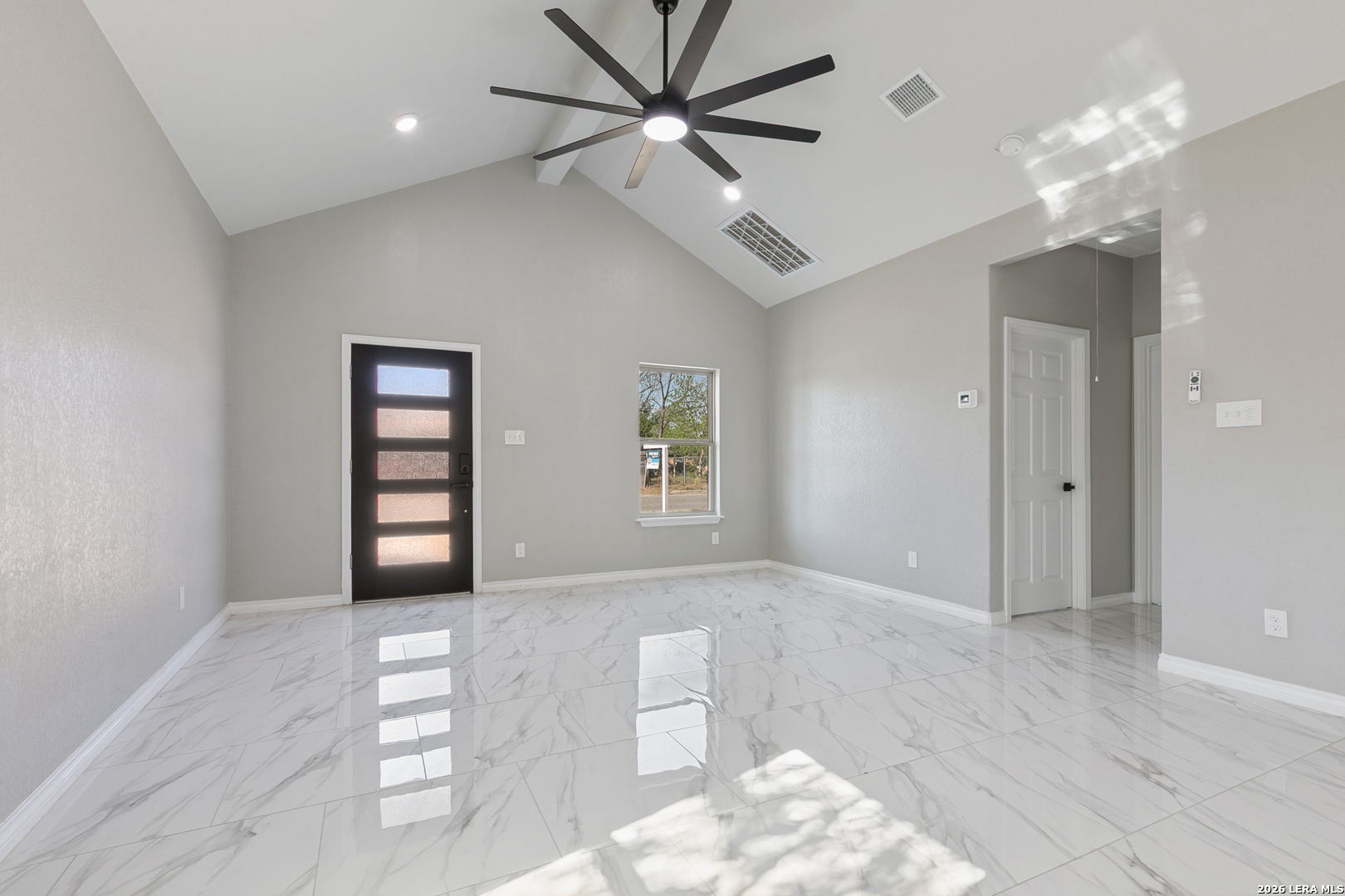 237 Avenue D Poteet, TX 78065 - Photo 6 of 27 wooden floor in an empty room with a window