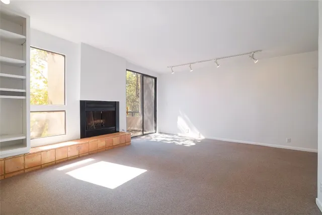 a view of empty room with fireplace