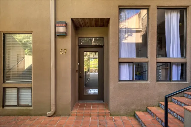 a view of a hallway with windows and entryway