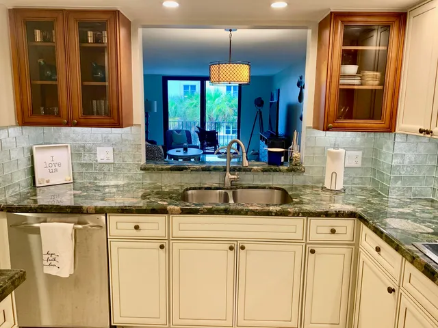 a kitchen with granite countertop a sink and cabinets