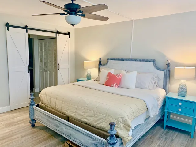 a bedroom with a bed and a chandelier