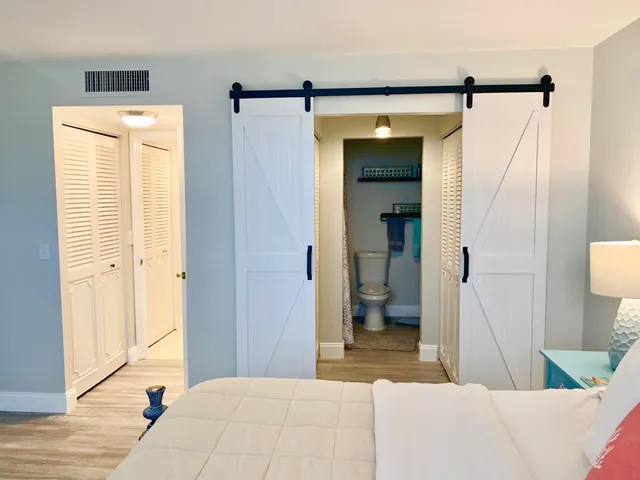 a bedroom with a bed and a mirror