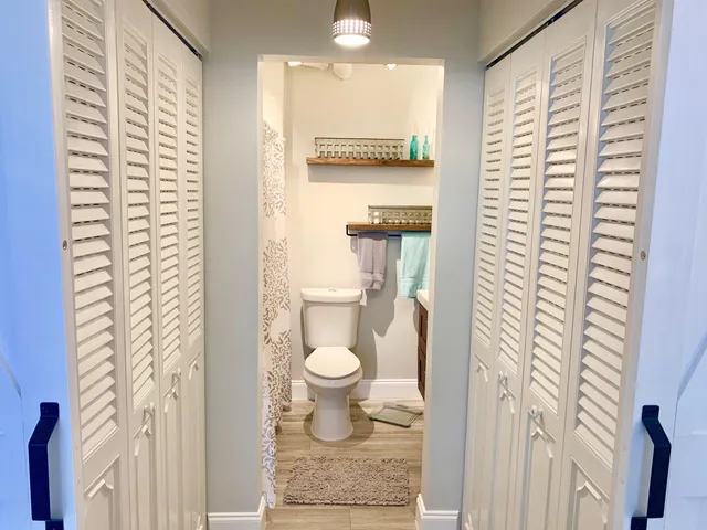 a bathroom with a toilet sink and mirror