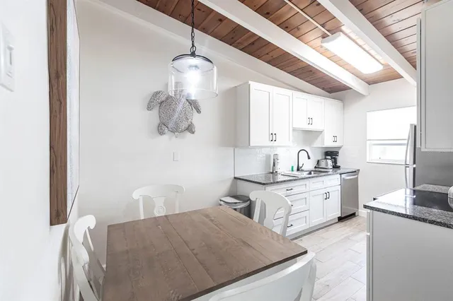 a kitchen with stainless steel appliances granite countertop a refrigerator sink and cabinets