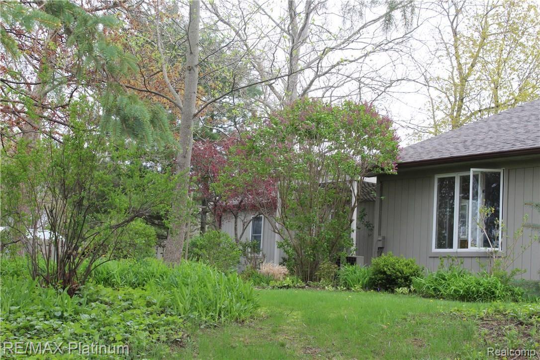 2215 Fenton Road Hartland, MI 48353 - Photo 12 of 15 View of back of house, lilacs in the spring