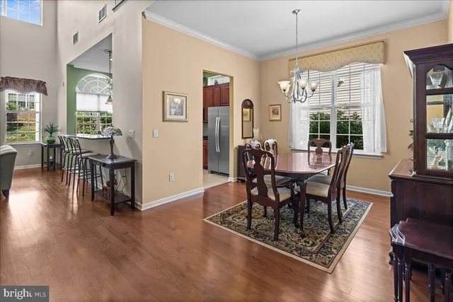 a dining room with furniture a rug and wooden floor