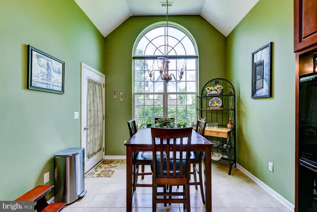 a kitchen with stainless steel appliances granite countertop a sink counter and chairs