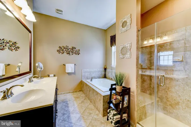 a spacious bedroom with a bed a dresser and a book shelf