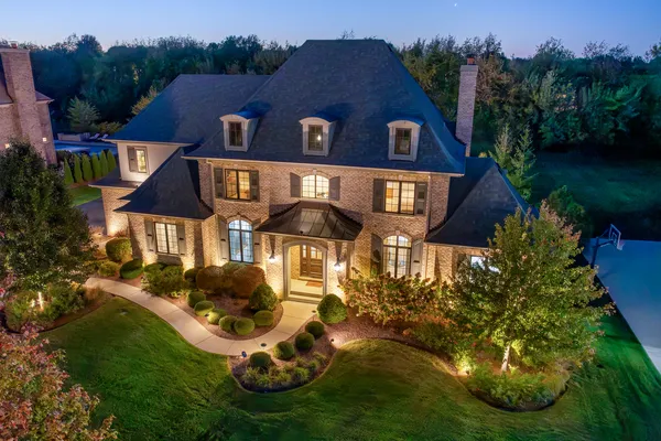 a aerial view of a house with swimming pool and garden
