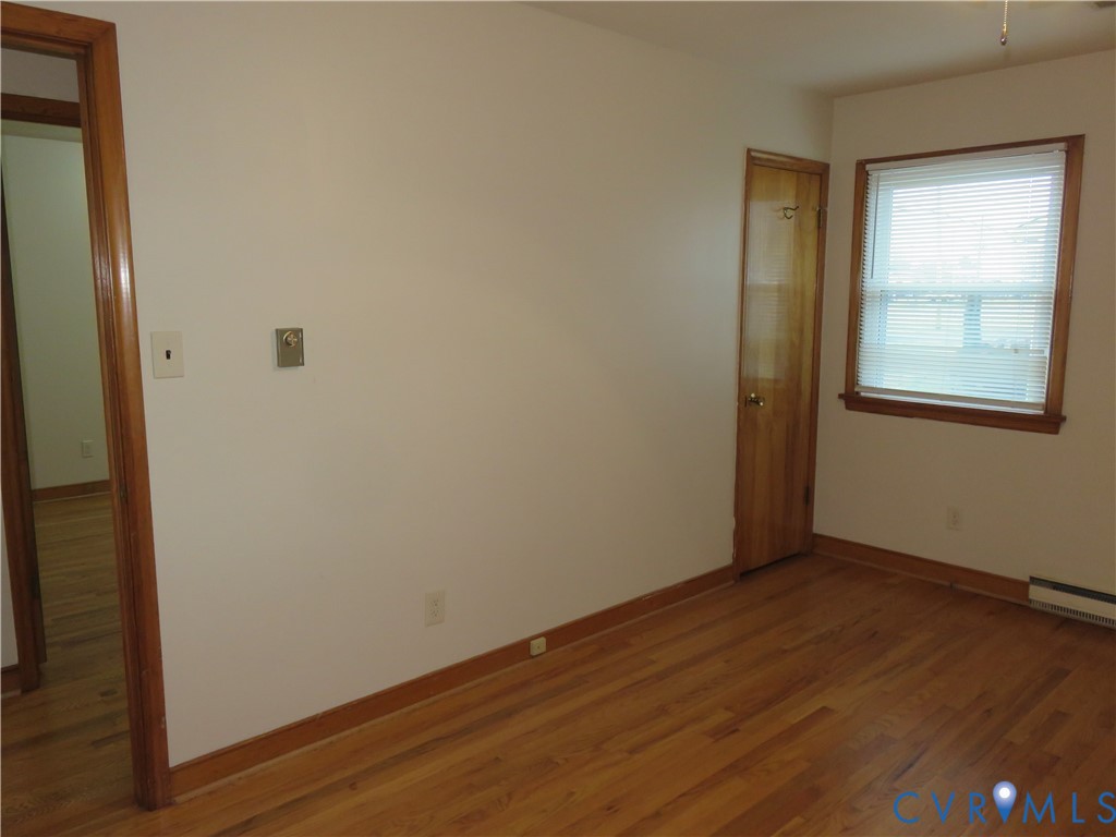 6729 Cold Harbor Road Mechanicsville, VA 23111 - Photo 11 of 22 a view of an empty room with wooden floor and a window