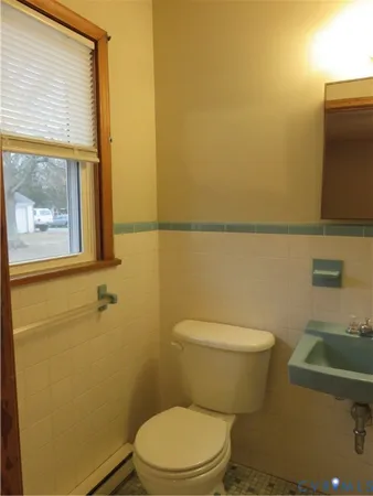 a white toilet sitting next to a bathroom sink