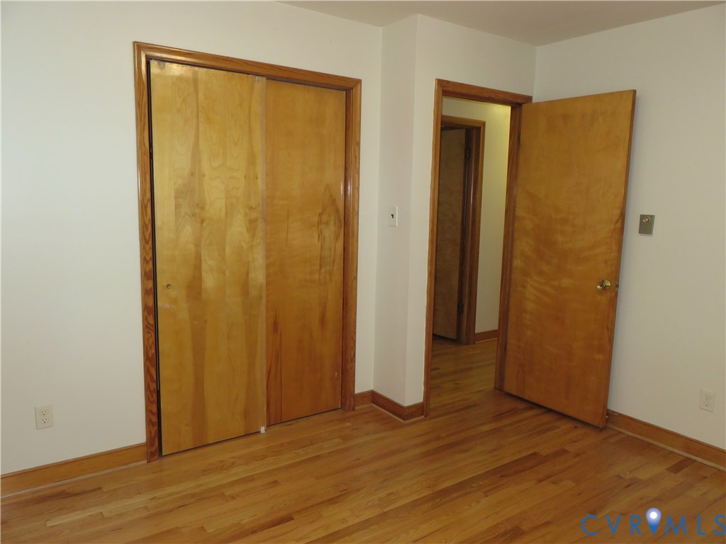 6729 Cold Harbor Road Mechanicsville, VA 23111 - Photo 15 of 22 an empty room with wooden floor and closet