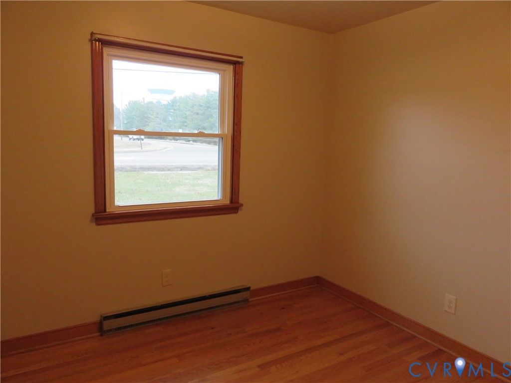 6729 Cold Harbor Road Mechanicsville, VA 23111 - Photo 16 of 22 a view of an empty room with wooden floor and a window
